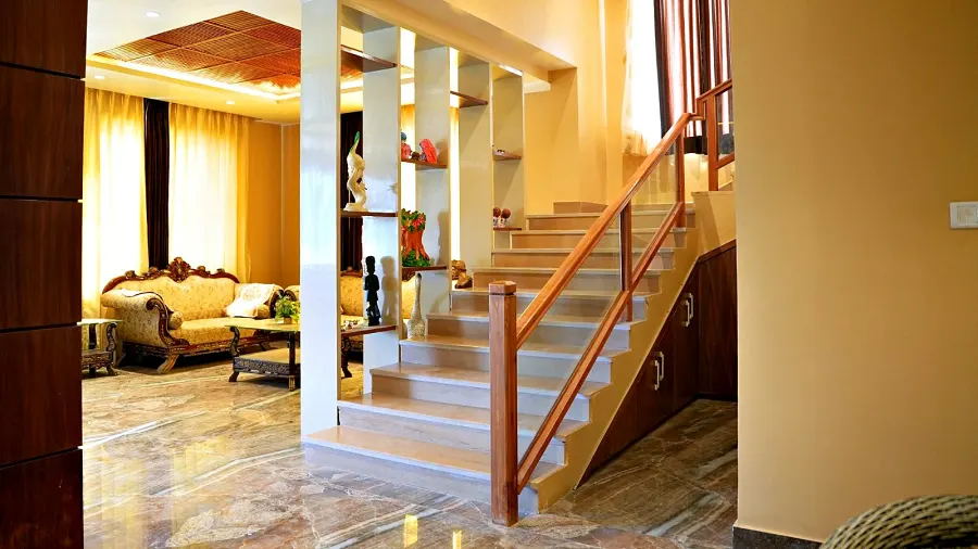 Internal staircase with a timber handrail connecting the villa three floors