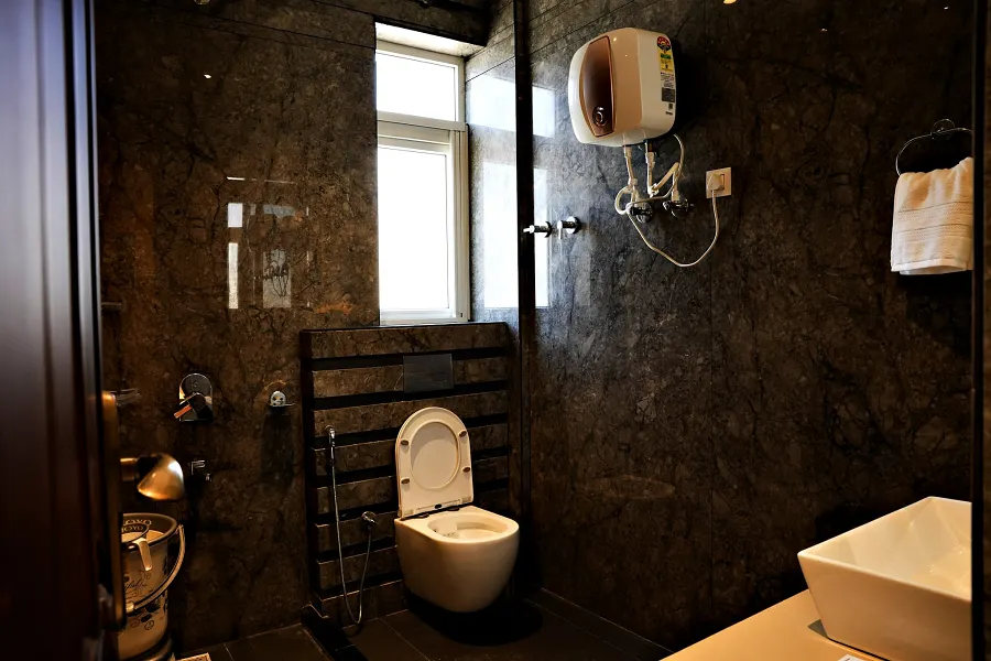 Bathroom with a stone feature wall, wall-hung basin and heated towel rail